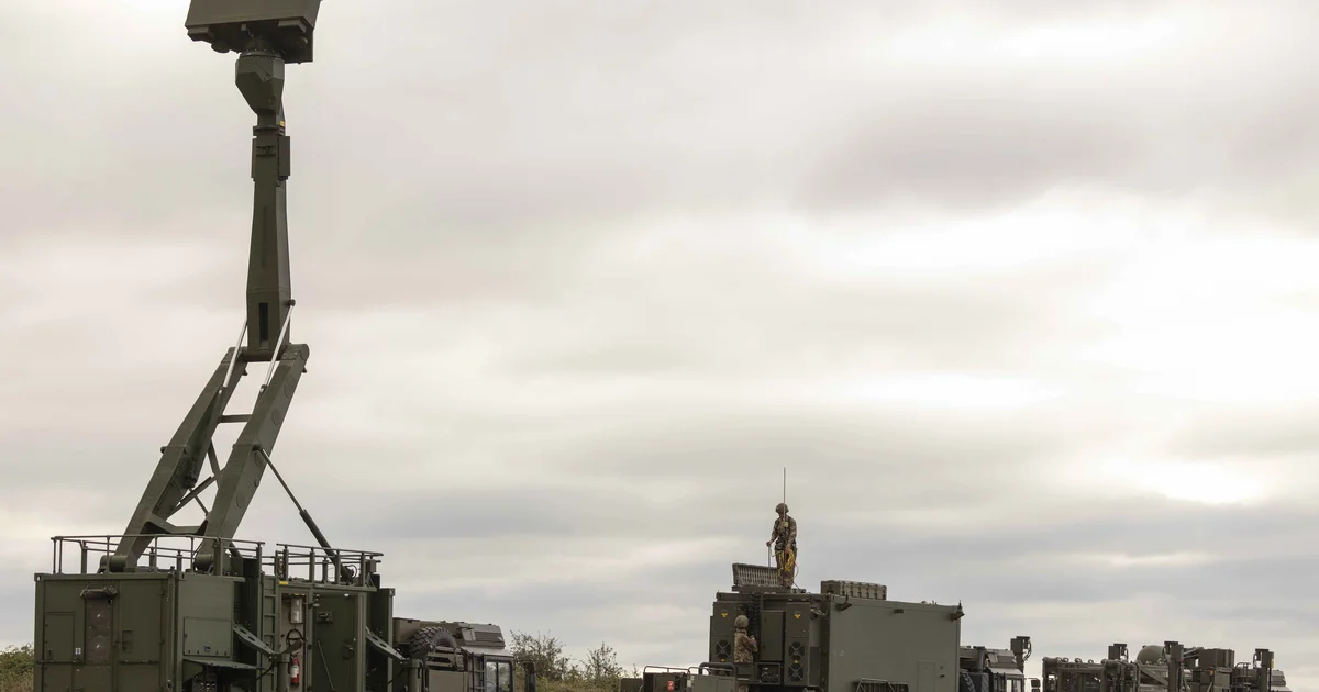 A military air-defence radar and missile system deployed on open ground.