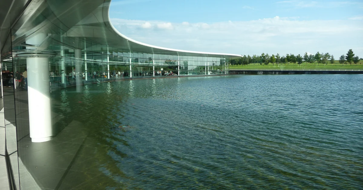 The McLaren Technology Centre building in Woking, seen from across the water.
