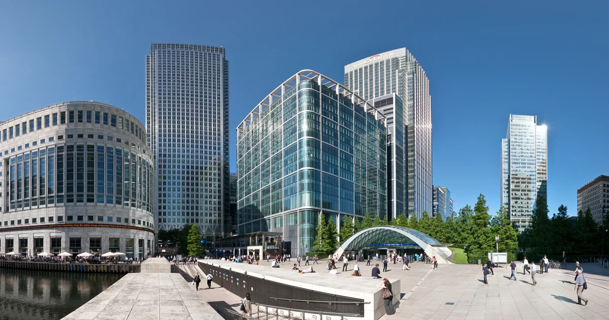 Canary Wharf skyline viewed from street level, including One Canada Square and the Reuters Building.